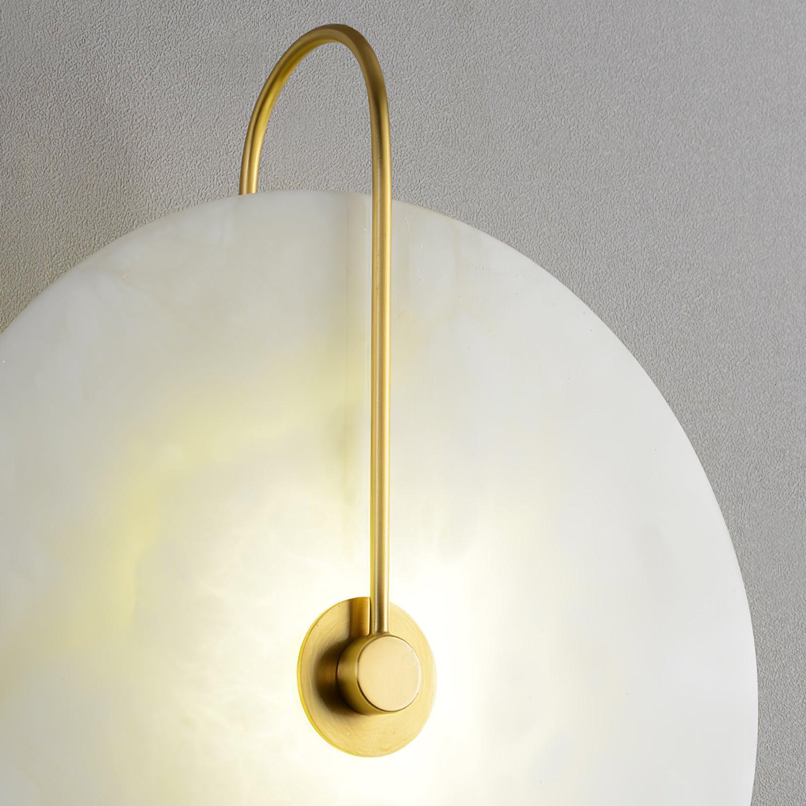 Close-up of the Clérachic Plug-In Wall Sconce from the side, gold rod and cloudy alabaster glowing on textured plaster.