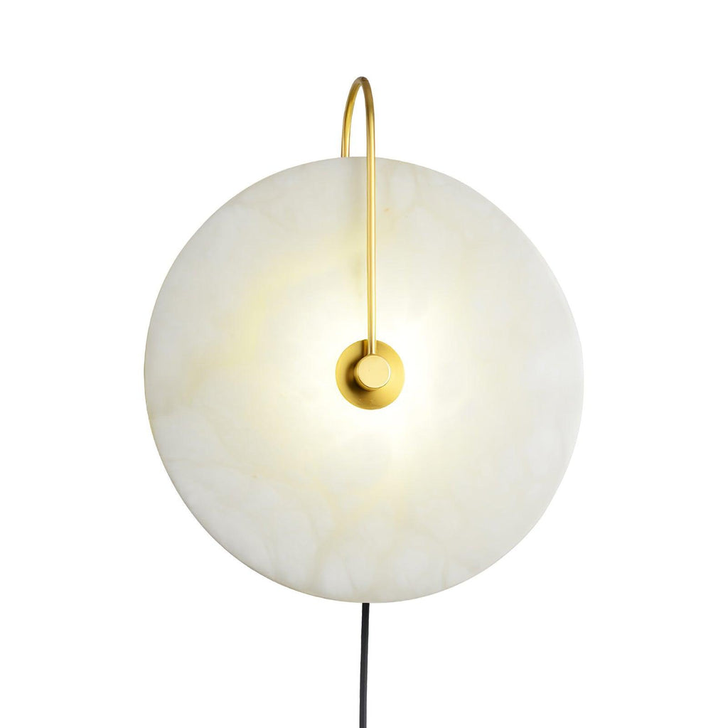 Clérachic Plug-In Wall Sconce centred on a white studio field, cream veining lit behind a polished gold centre plate.