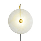 Clérachic Plug-In Wall Sconce centred on a white studio field, cream veining lit behind a polished gold centre plate.