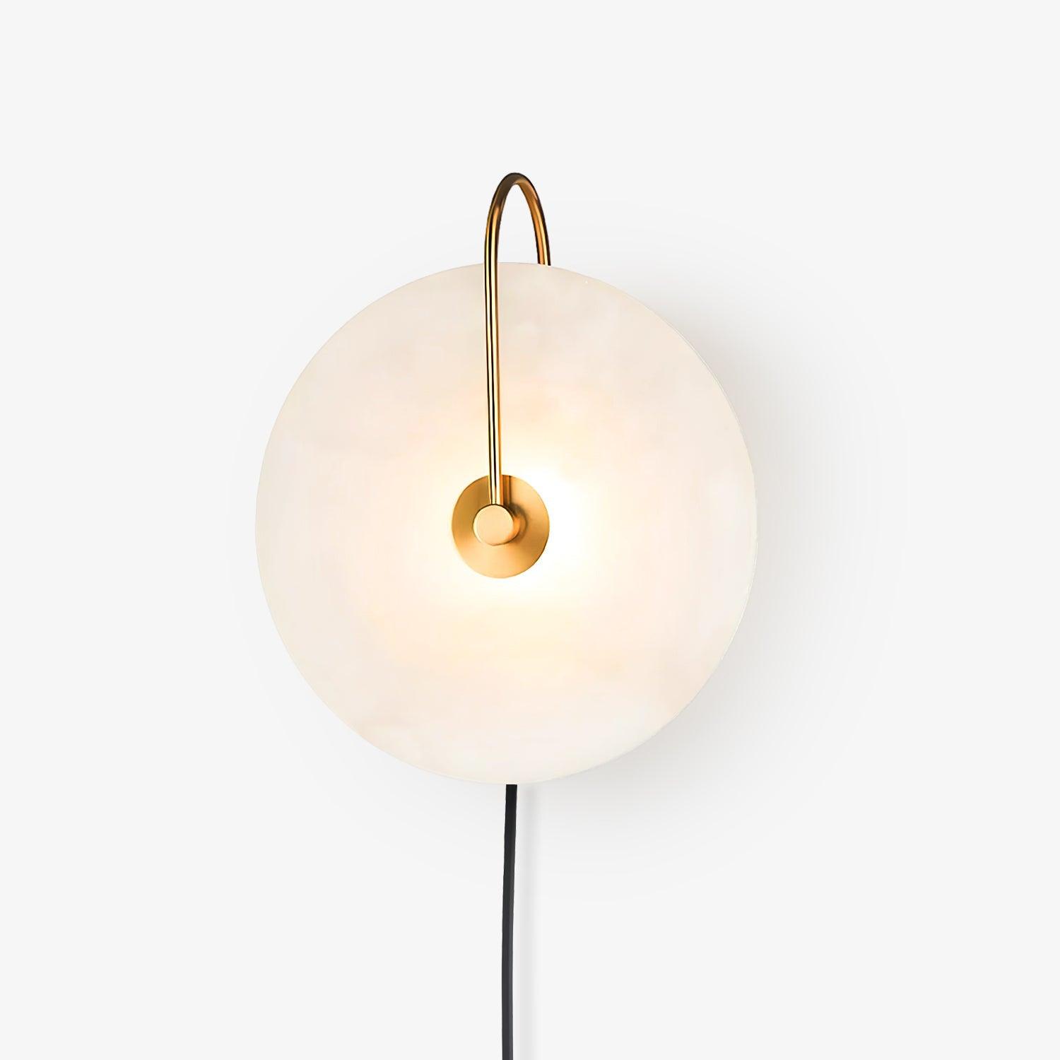 Isolated Clérachic Plug-In Wall Sconce on seamless white, gold hook arm and a bright hotspot behind the centre plate.