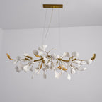 Unlit Clérachic chandelier, white leaves among gold branches with curved gold tips, hanging from two cables under a gold canopy.