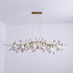 Clérachic leaf chandelier unlit against a pale lilac wall, with two suspension cables to a gold rectangular canopy.