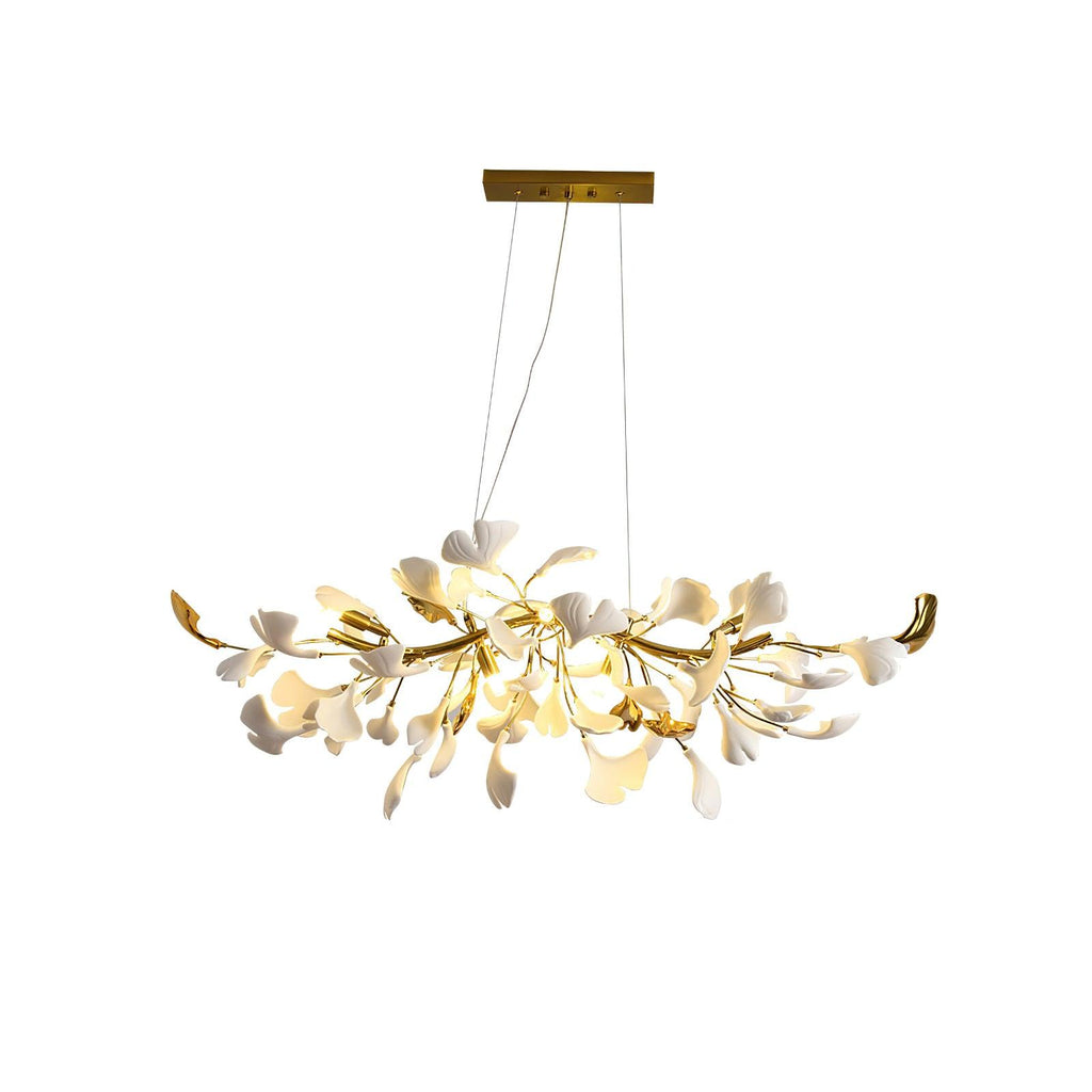 Lit Clérachic gold-bodied chandelier with white leaves and upturned gold tips, shown whole on a plain white backdrop.