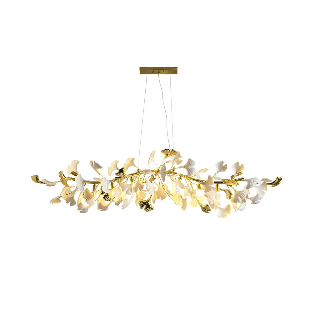 Clérachic chandelier with gold branch tips and gold-edged leaves among white ones, lit, on a plain white backdrop.