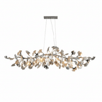 Wide Clérachic chandelier with polished silver leaf tips among white leaves, lit, hanging from a nickel canopy on a white backdrop.