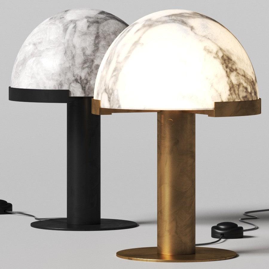 Two Clérachic table lamps side by side, one with a black base and one gold, both topped with veined white alabaster domes.