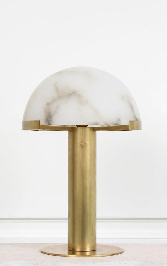 Front view of a gold Clérachic table lamp on a plain white ground, the cloud-veined alabaster dome resting on a brass collar.