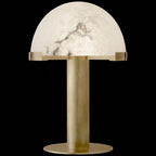 Gold Clérachic table lamp against a solid black backdrop, the veined alabaster dome clearly picked out above the tall brass stem.
