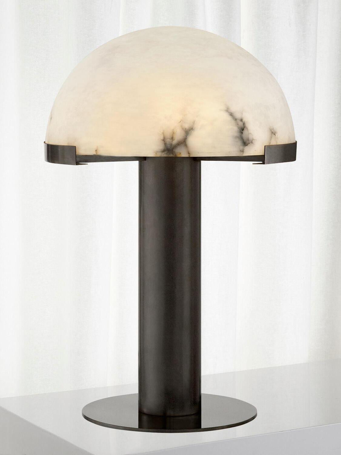 Dark-based Clérachic table lamp with a dome of soft grey-black veining, against a sheer white curtain.