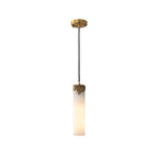 Clérachic Quiver Pendant Light in the taller alabaster size, its slim stone cylinder and brass cap hanging from a long black cord on white.