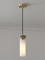 Clérachic Quiver Pendant Light switched on against a plain wall, warm light travelling through the stone instead of spilling from the bulb.