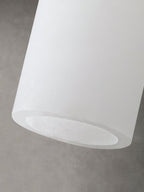 Close view of the open base of the Clérachic Quiver Pendant Light, showing the cut edge and the real thickness of the natural alabaster.