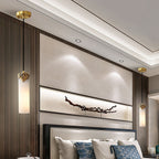 A pair of Clérachic Quiver Pendant Lights flanking a bed, one hung each side of the headboard in place of table lamps.