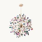 This Clérachic chandelier on a plain backdrop: a round burst of fine gold branches tipped with multicolour agate slices, hung from a slim rod.