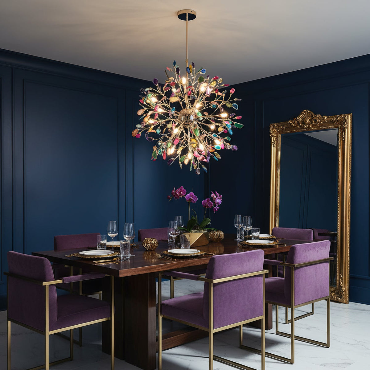 Clérachic agate chandelier lit above a dark wood dining table, with purple chairs and a tall gilt mirror against navy panelled walls.