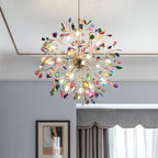 Clérachic multicolour agate chandelier seen from below, lit, in a room with a grey wall, a framed print and heavy curtains.