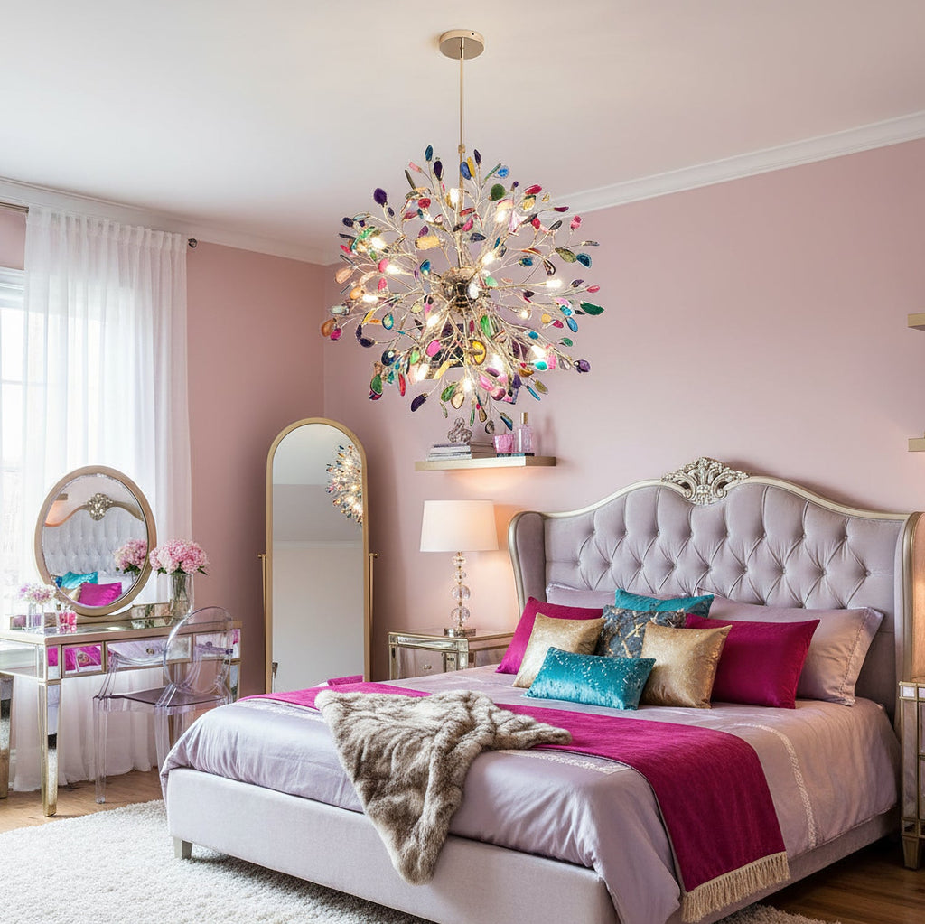 Clérachic agate chandelier above a bed with a tufted headboard and a magenta throw, in a pink bedroom with a mirrored dressing table.