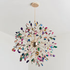 Clérachic agate chandelier seen from below on a pale ceiling, with a gold sphere at the centre and slices in many colours.
