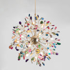 Multicolour agate Clérachic chandelier on a pale grey backdrop, with a gold sphere and branches radiating in all directions.