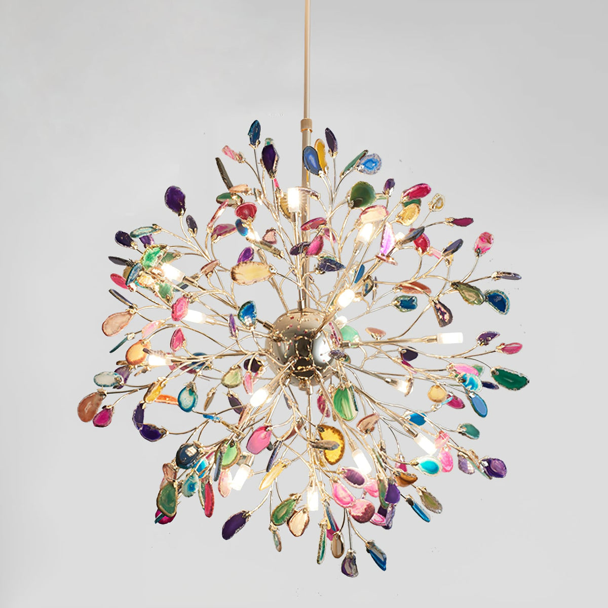 Multicolour agate Clérachic chandelier on a pale grey backdrop, with a gold sphere and branches radiating in all directions.