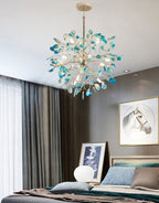 Blue and teal agate Clérachic chandelier above a bedroom with a grey wall, dark curtains and a framed horse print.