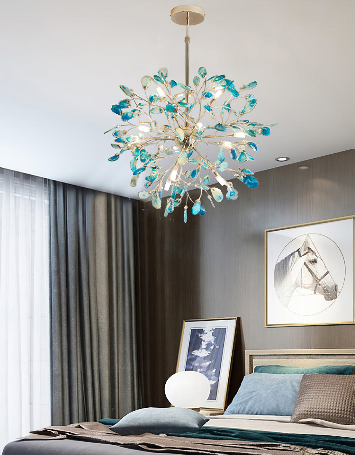 Blue and teal agate Clérachic chandelier above a bedroom with a grey wall, dark curtains and a framed horse print.
