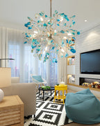 Blue and teal agate Clérachic chandelier in a living room with a white brick wall, a yellow stool and a teal bean bag.