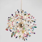 Close view from below of a lit multicolour Clérachic agate chandelier, with slices in pink, blue, green and amber around a gold sphere.
