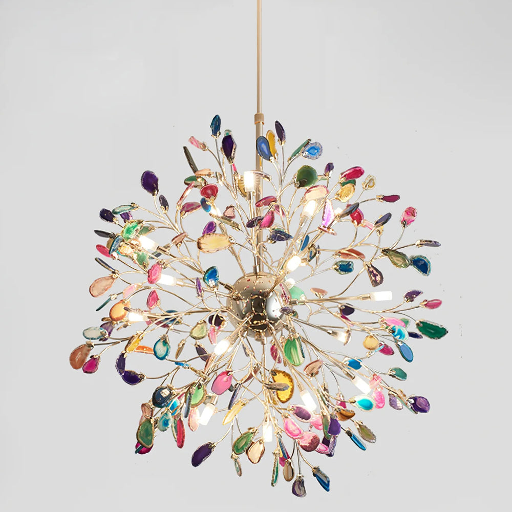 Close view from below of a lit multicolour Clérachic agate chandelier, with slices in pink, blue, green and amber around a gold sphere.