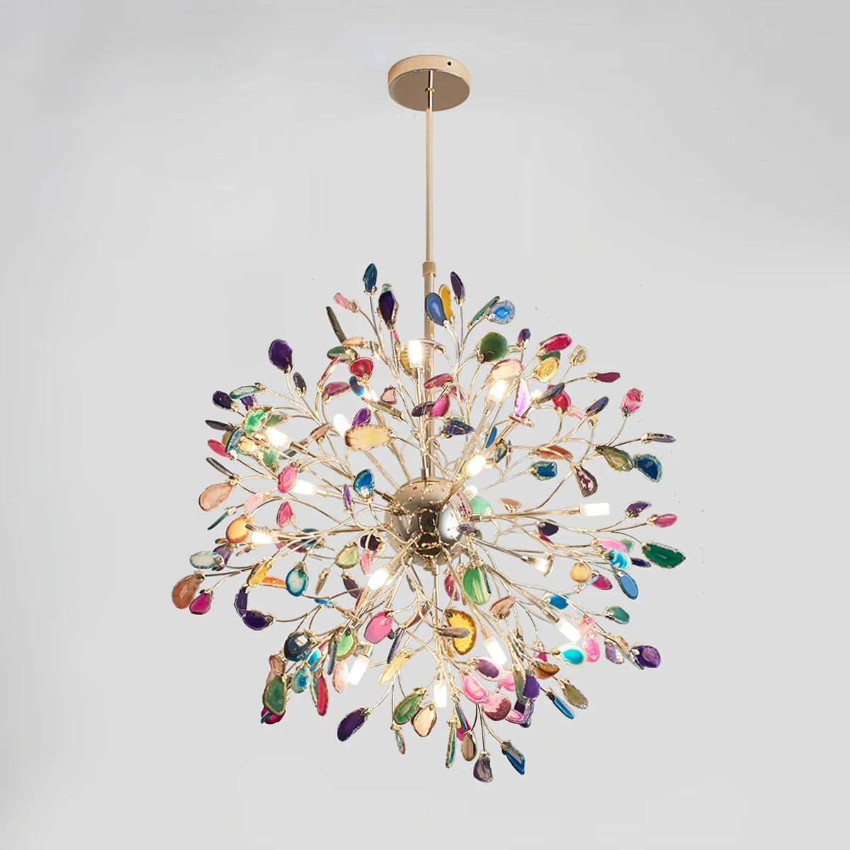 Lit multicolour Clérachic agate chandelier on a grey backdrop, with a gold rod and branches spreading in a full sphere.