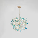 Blue and teal agate Clérachic chandelier on a pale grey backdrop, lit, hanging from a gold rod and round canopy.