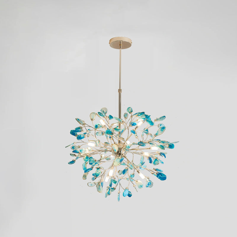 Blue and teal agate Clérachic chandelier on a pale grey backdrop, lit, hanging from a gold rod and round canopy.