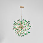 Green agate Clérachic chandelier on a pale grey backdrop, lit, hanging from a gold rod and round canopy.