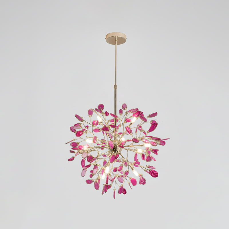 Pink and magenta agate Clérachic chandelier on a pale grey backdrop, lit, hanging from a gold rod and round canopy.