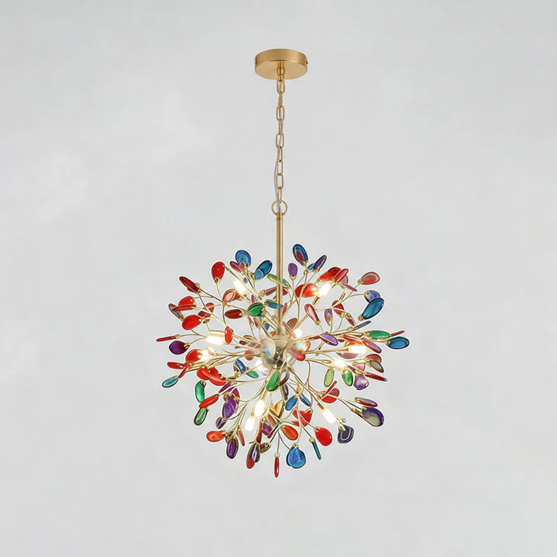Clérachic agate chandelier with red, blue and green slices, hanging from a gold chain on a pale grey backdrop.