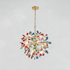 Clérachic agate chandelier with red, blue and green slices, hanging from a gold chain on a pale grey backdrop.