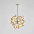 Amber agate Clérachic chandelier hanging from a fine gold chain, on a pale grey backdrop.