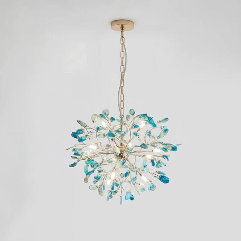 Blue and teal agate Clérachic chandelier hanging from a gold chain and round canopy on a pale grey backdrop.