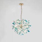 Blue and teal agate Clérachic chandelier hanging from a gold chain and round canopy on a pale grey backdrop.
