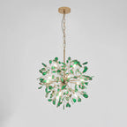 Green agate Clérachic chandelier hanging from a gold chain and round canopy, on a pale grey backdrop.