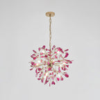 Pink agate Clérachic chandelier hanging from a gold chain on a pale grey backdrop, with rose slices around a central hub.