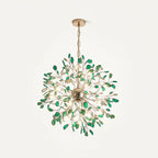 Green agate Clérachic chandelier hanging from a chain on a cream backdrop, with deep green slices around a gold sphere.