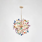 Clérachic agate chandelier on a chain, with multicolour slices in blue, green, orange and pink on a pale grey backdrop.