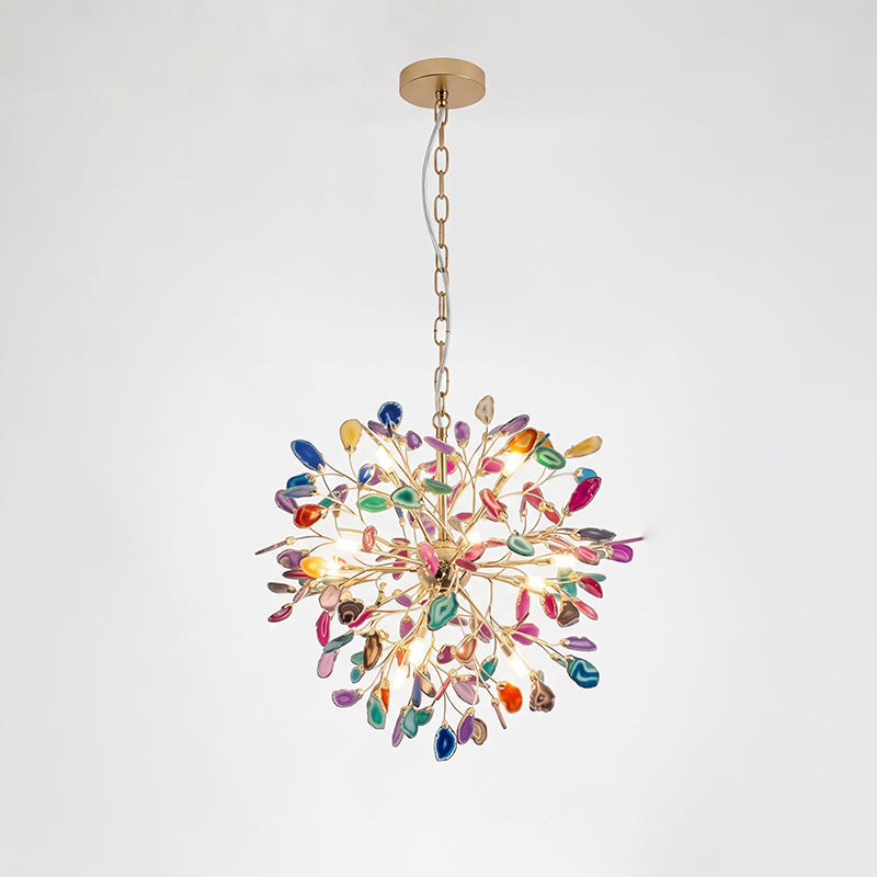 A small multicolour Clérachic agate chandelier on a gold chain, with slices in orange, green, pink and blue on a pale backdrop.