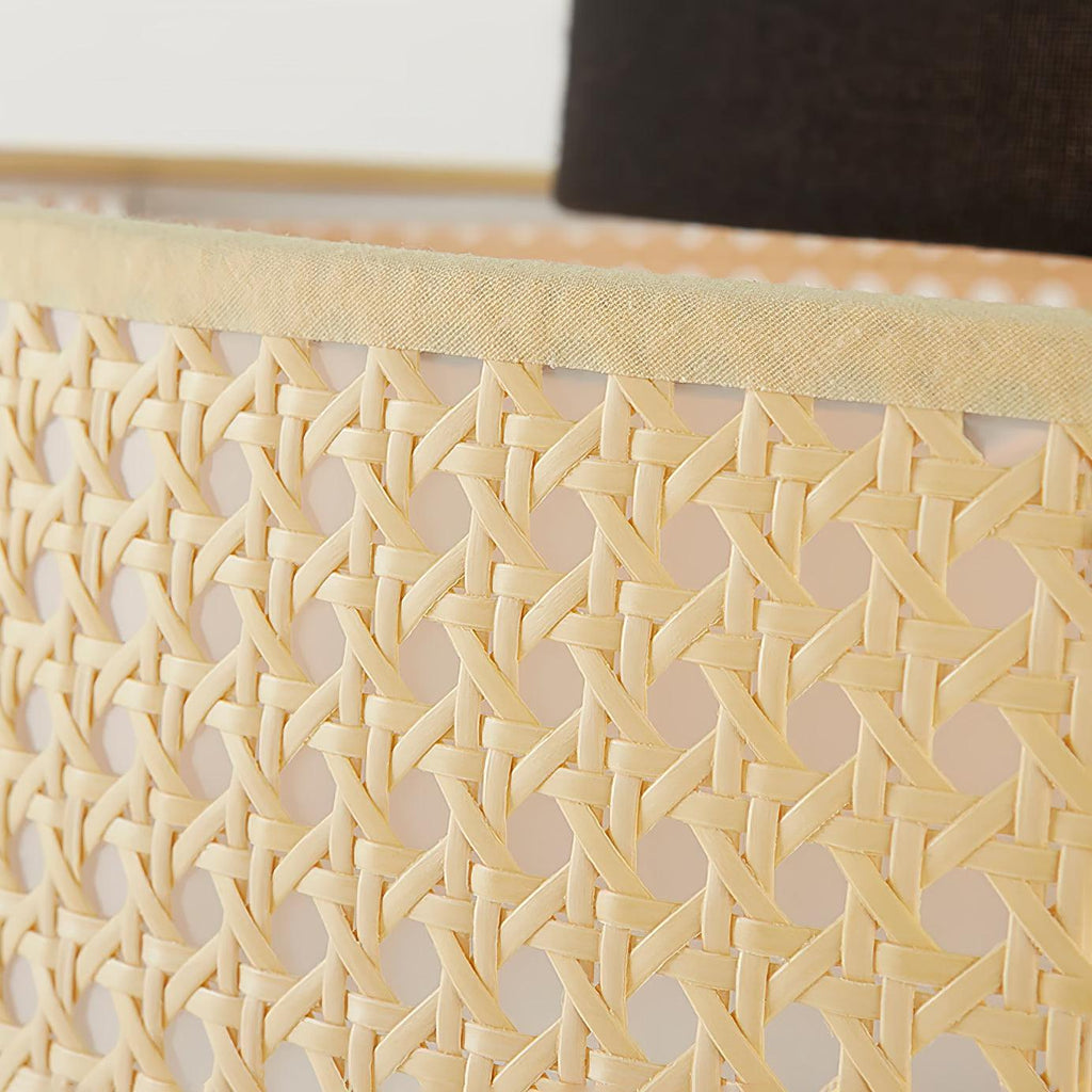 Close view of the open woven cane on the drum shade of this Clérachic pendant, with a cream trim along the edge.