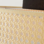 Close view of the open woven cane on the drum shade of this Clérachic pendant, with a cream trim along the edge.