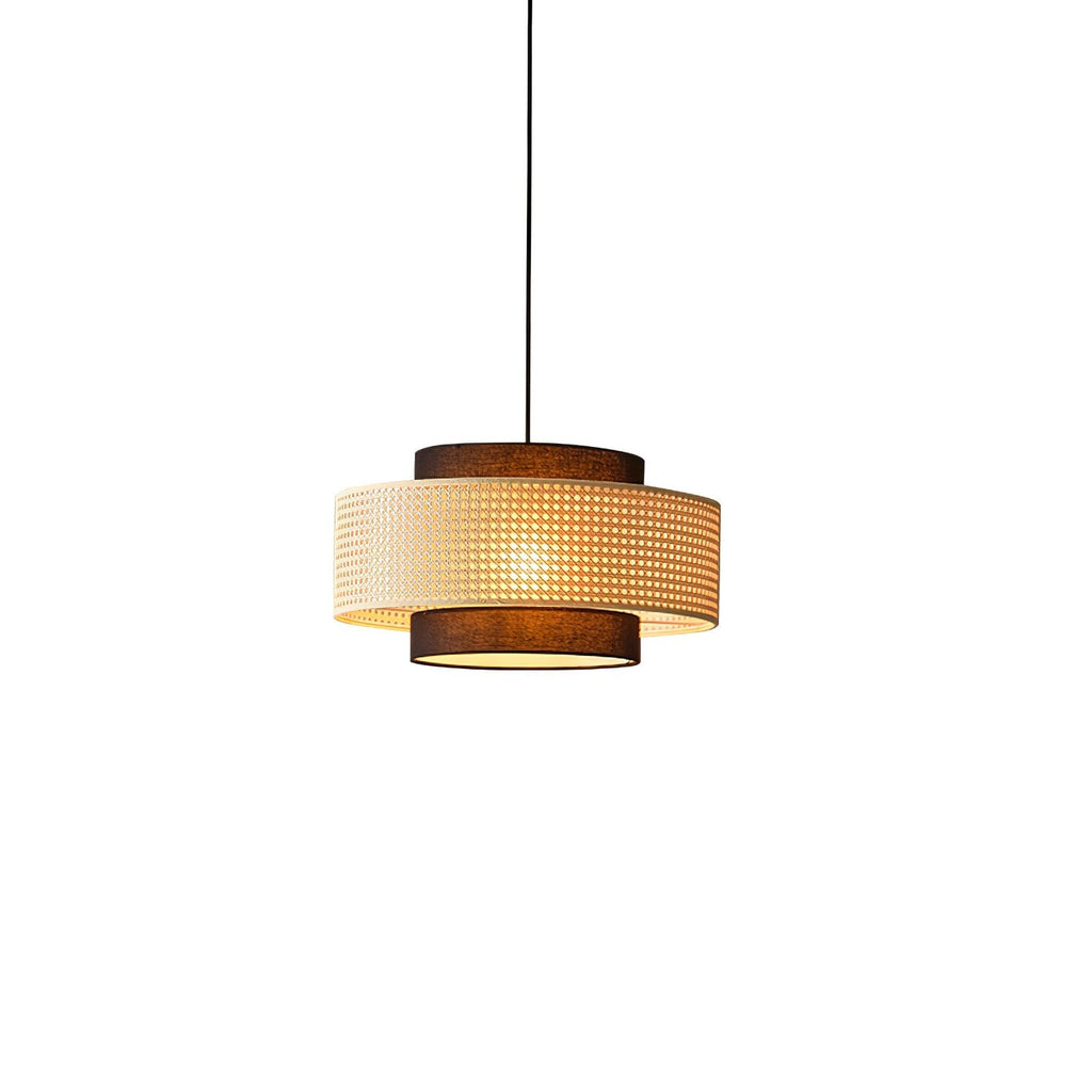 This Clérachic pendant on a white backdrop shows a wide rattan drum between two narrower brown fabric tiers.