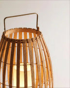 Close view of the Clérachic lantern rim, with a bound top ring, a brass-toned handle and a softly lit inner pillar.