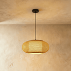 Clérachic mid-size woven pendant light with a wide crosshatch weave and a lit diffuser disc below, on a black cord.