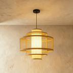 Clérachic mid-size tiered slatted pendant light, stacked wooden rings around a lit cylindrical inner shade.